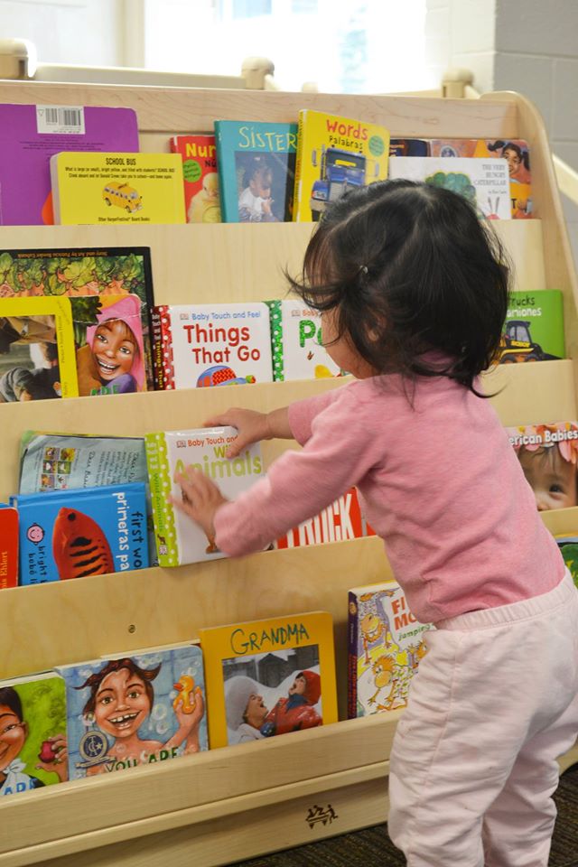child by bookshelf